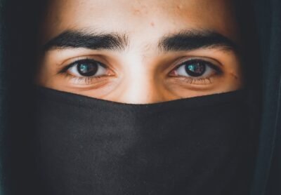 person in black hijab taking selfie