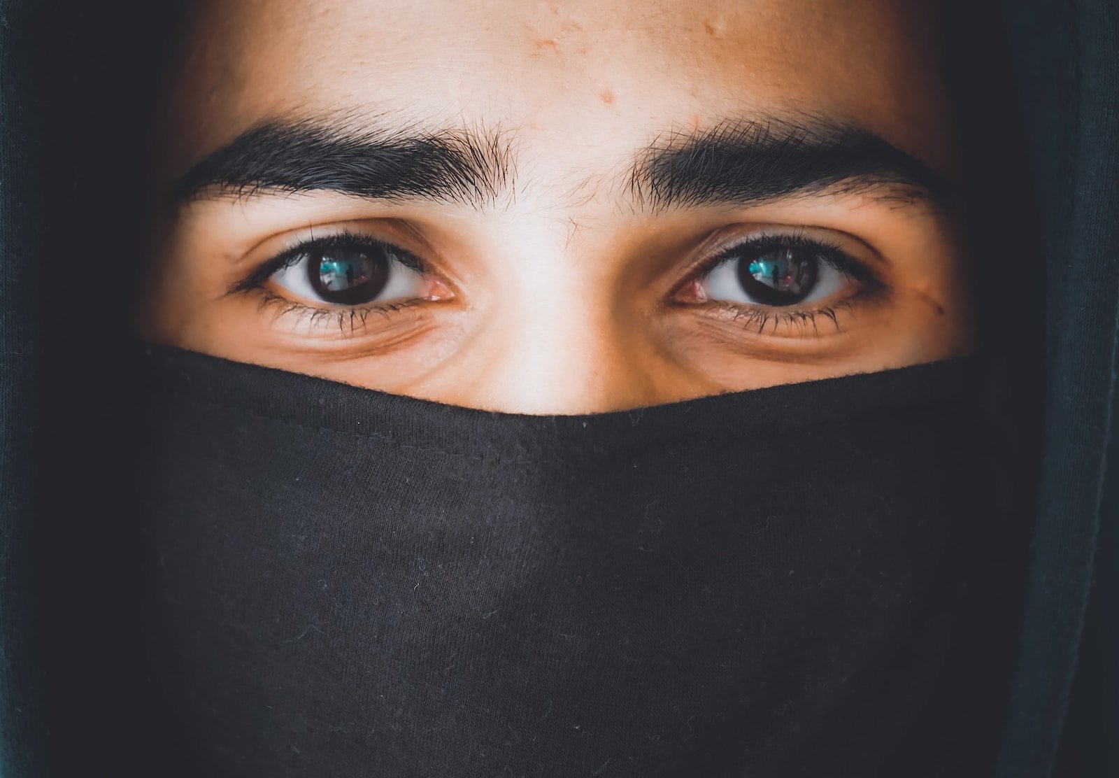 person in black hijab taking selfie